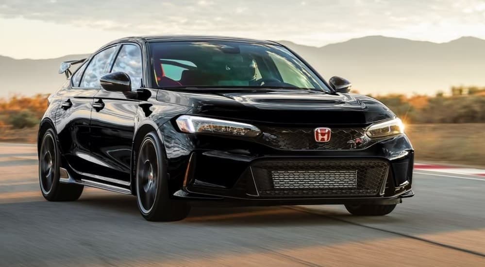 A black 2023 Honda Civic Type-R Hatchback driving on a track.