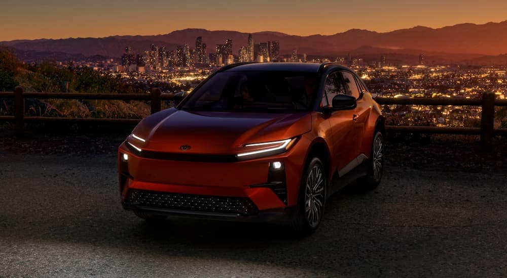 Orange 2026 2026 Toyota CH-R parked in a city a night