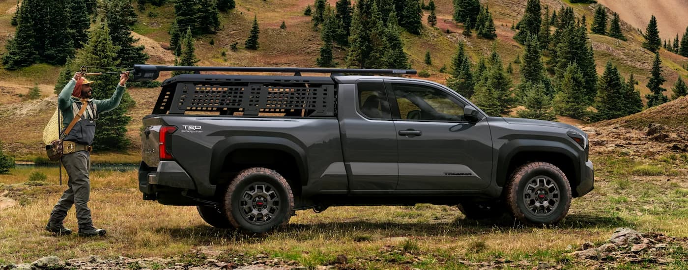Black 2025 Toyota Tacoma PreRunner parked on a grassy trail