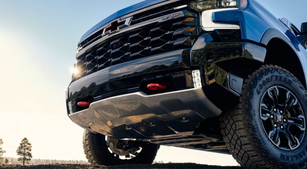 The front of a blue 2025 Chevy Silverado 1500 ZR2 is shown from a low angle.